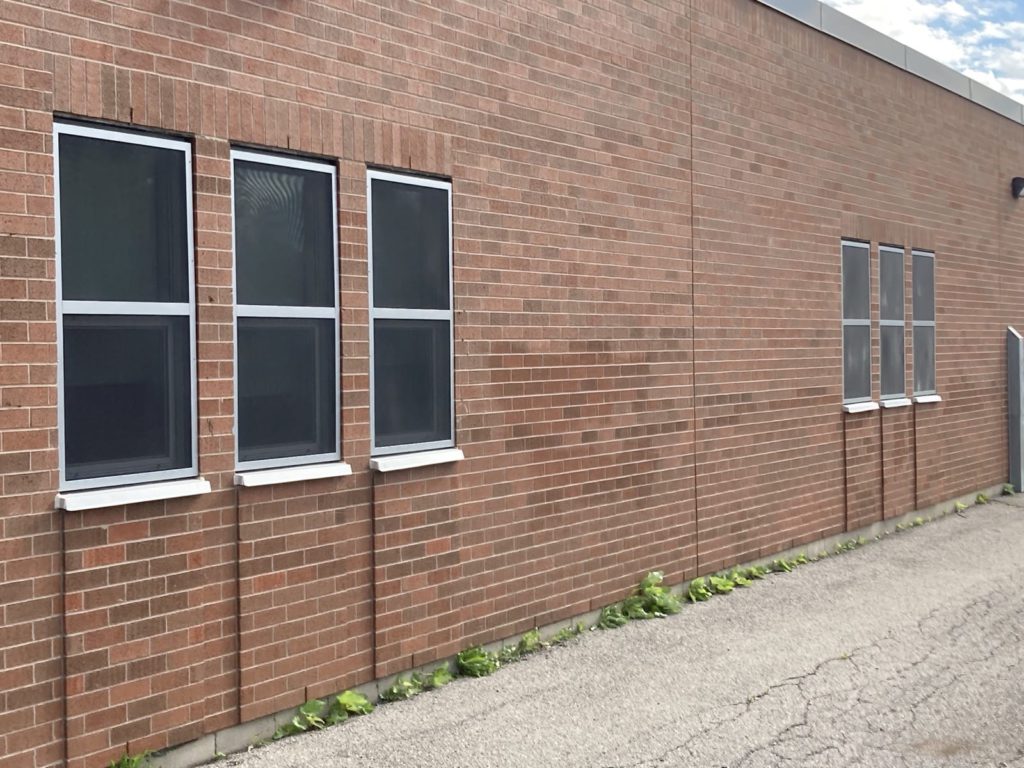 Fixed security screen on red brick school building